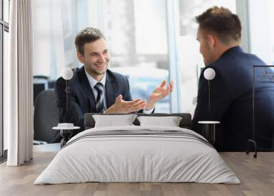 business partners talking while sitting at your desk Wall mural