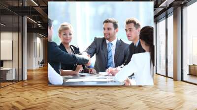 Business people shaking hands, finishing up a meeting Wall mural