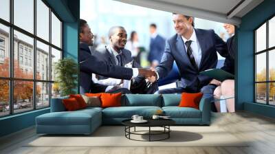 Business people shaking hands, finishing up a meeting Wall mural