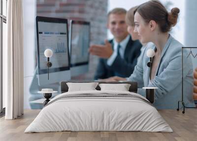 business team discussing financial charts on a workplace Wall mural