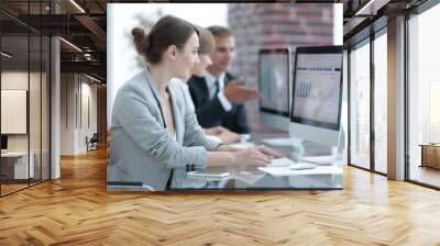 business team discussing financial charts on a workplace Wall mural