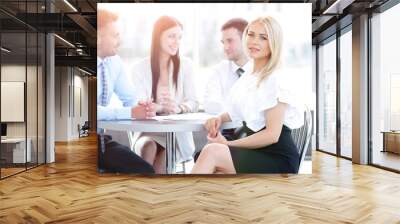 business team sitting at a table in a cafe, on a work break Wall mural