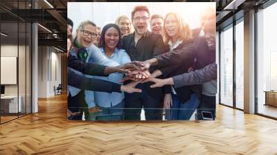 Business team stacking their hands together Wall mural