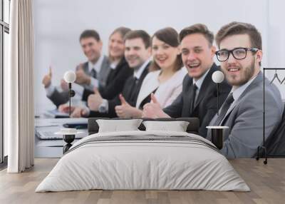 business team with thumbs up while sitting at his Desk Wall mural