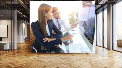 business woman with a colleague sitting at a Desk Wall mural