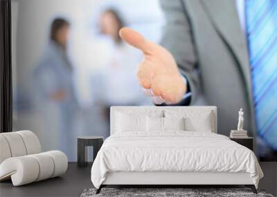 businessman extending hand to shake Wall mural