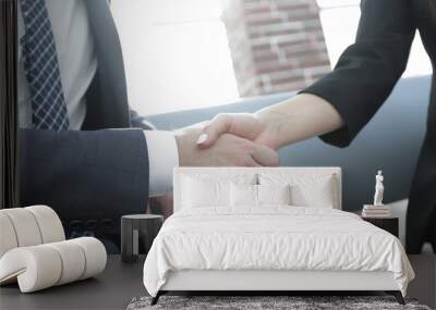 Businessman shaking hands to seal a deal with his partner Wall mural