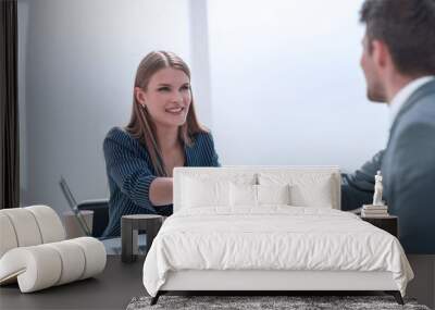 businessman shaking hands with businesswoman sitting at the negotiating table Wall mural