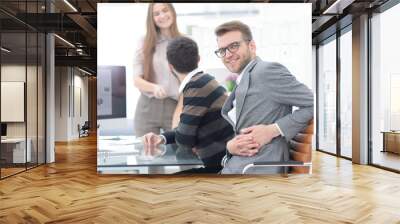 businessman sitting at his Desk in the office Wall mural