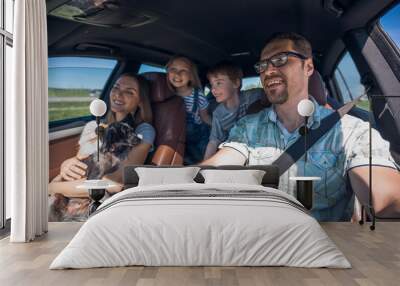 cheerful family with two children goes to the car Wall mural