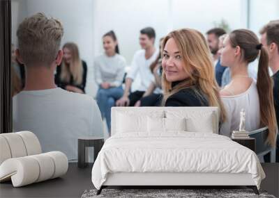 close up. a young woman sitting in a circle of like-minded people. Wall mural