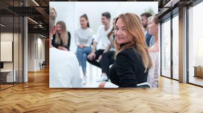 close up. a young woman sitting in a circle of like-minded people. Wall mural