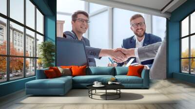 close up. business people shaking hands at a meeting in the office Wall mural