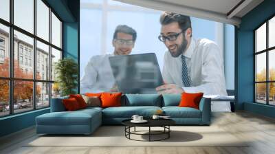 close up.a happy employee looking at the laptop screen Wall mural