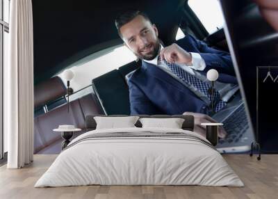 Confident businessman sitting in car Wall mural