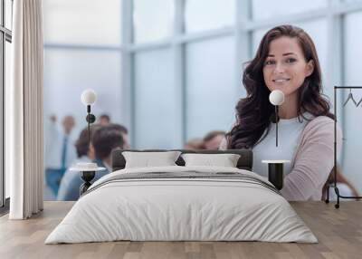 confident young business woman on the background of the office. Wall mural