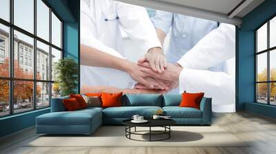 doctors holding hands together at hospital Wall mural