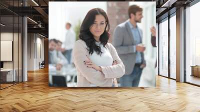 Executive young woman standing in modern office. Wall mural