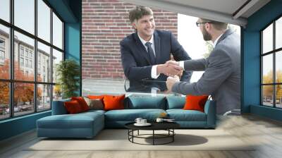 greeting handshake of colleagues at the desk Wall mural