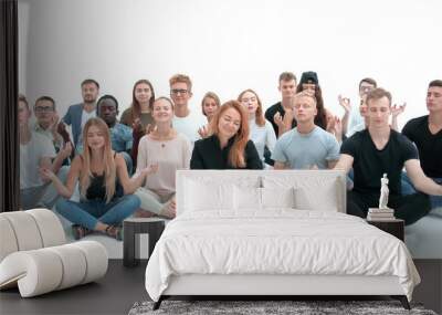 group of concentrated young people sitting on the floor. Wall mural