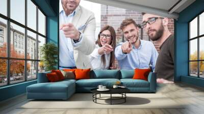 group of employees pointing their fingers at you. Wall mural