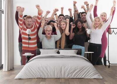 group of happy people standing with their hands up . Wall mural