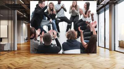 group of seminar participants applauds sitting in a circle Wall mural