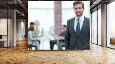 handsome businessman smiling with his colleagues behind Wall mural