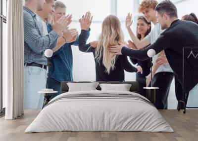 happy business team giving each other a high five. Wall mural