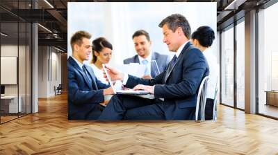 Happy businessman using laptop in business building, Wall mural