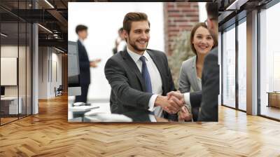 happy man introducing businesswoman to business partners Wall mural