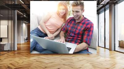 Happy modern couple surfing the net and working on laptop at home Wall mural