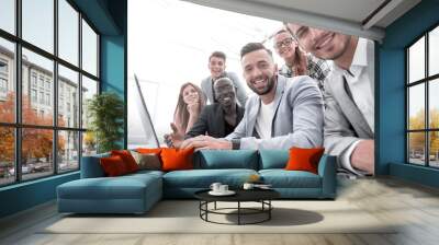 Happy smiling multi-ethnic creative millennial team excited by online result or growth Wall mural