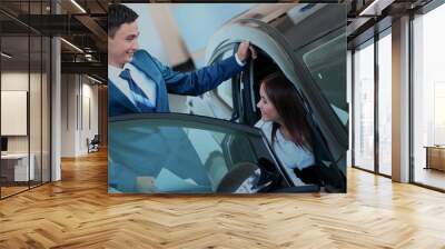 happy woman inside car in auto show or salon Wall mural