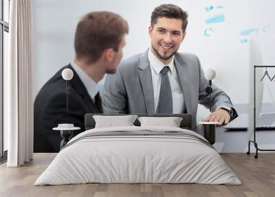 image of two young businessmen discussing project at meeting Wall mural