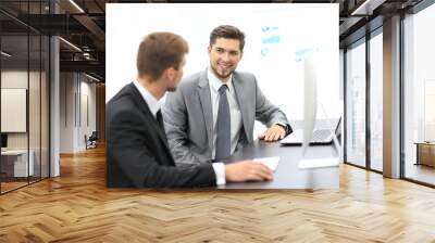 image of two young businessmen discussing project at meeting Wall mural