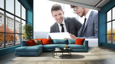 Image of two young businessmen using touchpad at meeting Wall mural