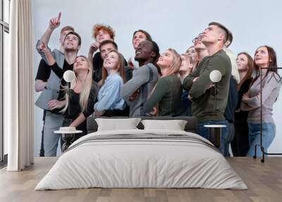 large group of friends looking up hopefully . isolated on white Wall mural