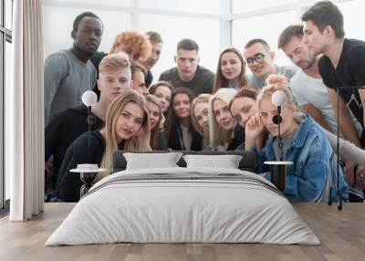 large group of friends sitting at a table Wall mural