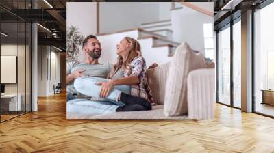 loving couple relaxing on the couch on a free evening Wall mural