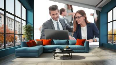 man and woman sitting at table in co-working office Wall mural