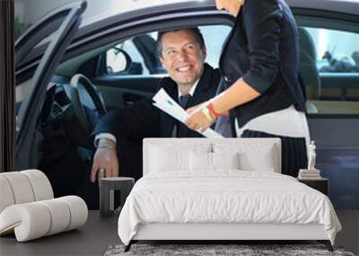 Man buying a car in dealership sitting in his new auto Wall mural