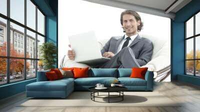 modern businessman with a laptop sitting in a stylish comfortable chair Wall mural