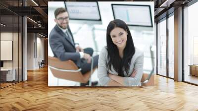 Portrait of a young business woman on a workplace background Wall mural