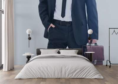 Portrait of an elegant handsome business man with  suitcase on w Wall mural