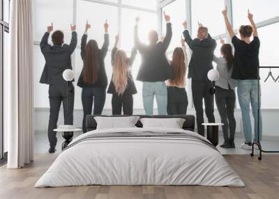 rear view. a group of business people together pointing up at a copy of the space Wall mural