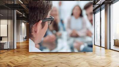 rear view. background image of a businessman sitting at a busine Wall mural