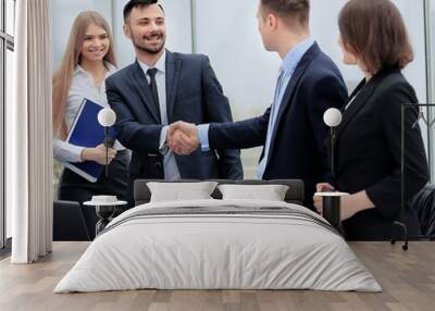 shaking hands in the office at the beginning of the working day Wall mural