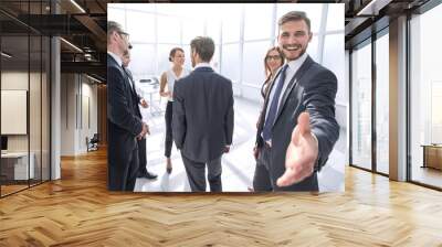 smiling businessman gives hand for handshake Wall mural