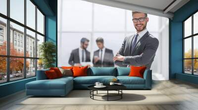 smiling businessman on blurred office background Wall mural